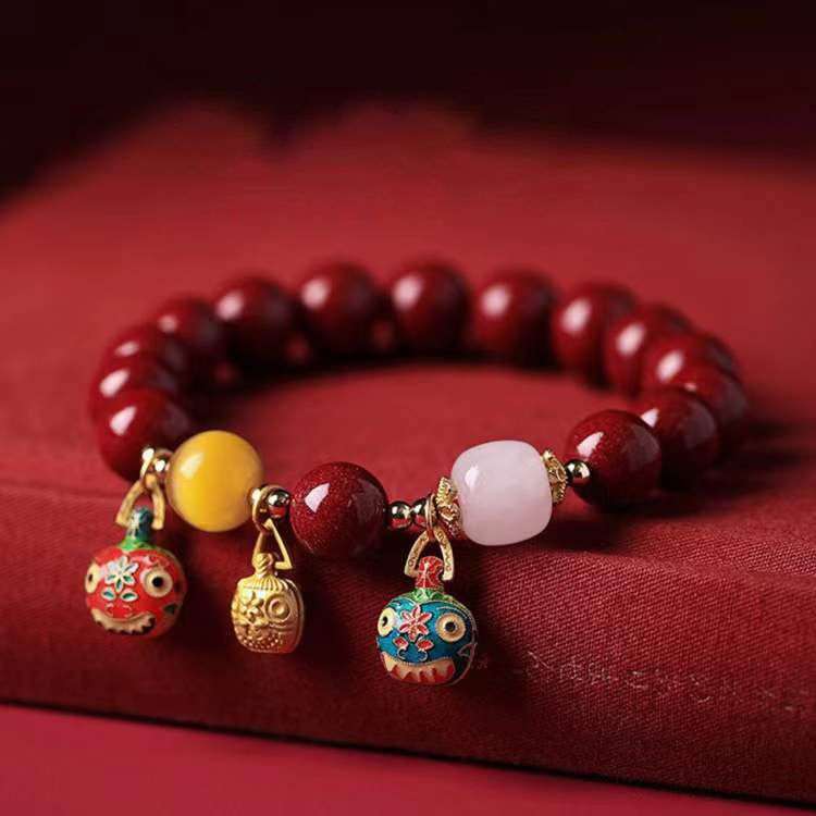 Elegant Red Cinnabar Bracelet with Cloisonné Golden Beasts Trio, White Jade, Yellow Amber, and 18K Gold Accents