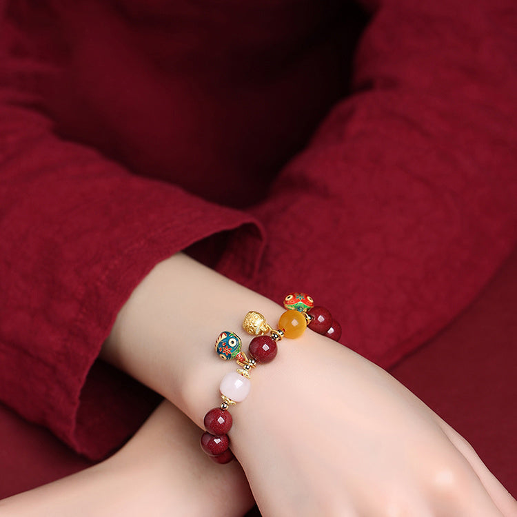 Elegant Red Cinnabar Bracelet with Cloisonné Golden Beasts Trio, White Jade, Yellow Amber, and 18K Gold Accents